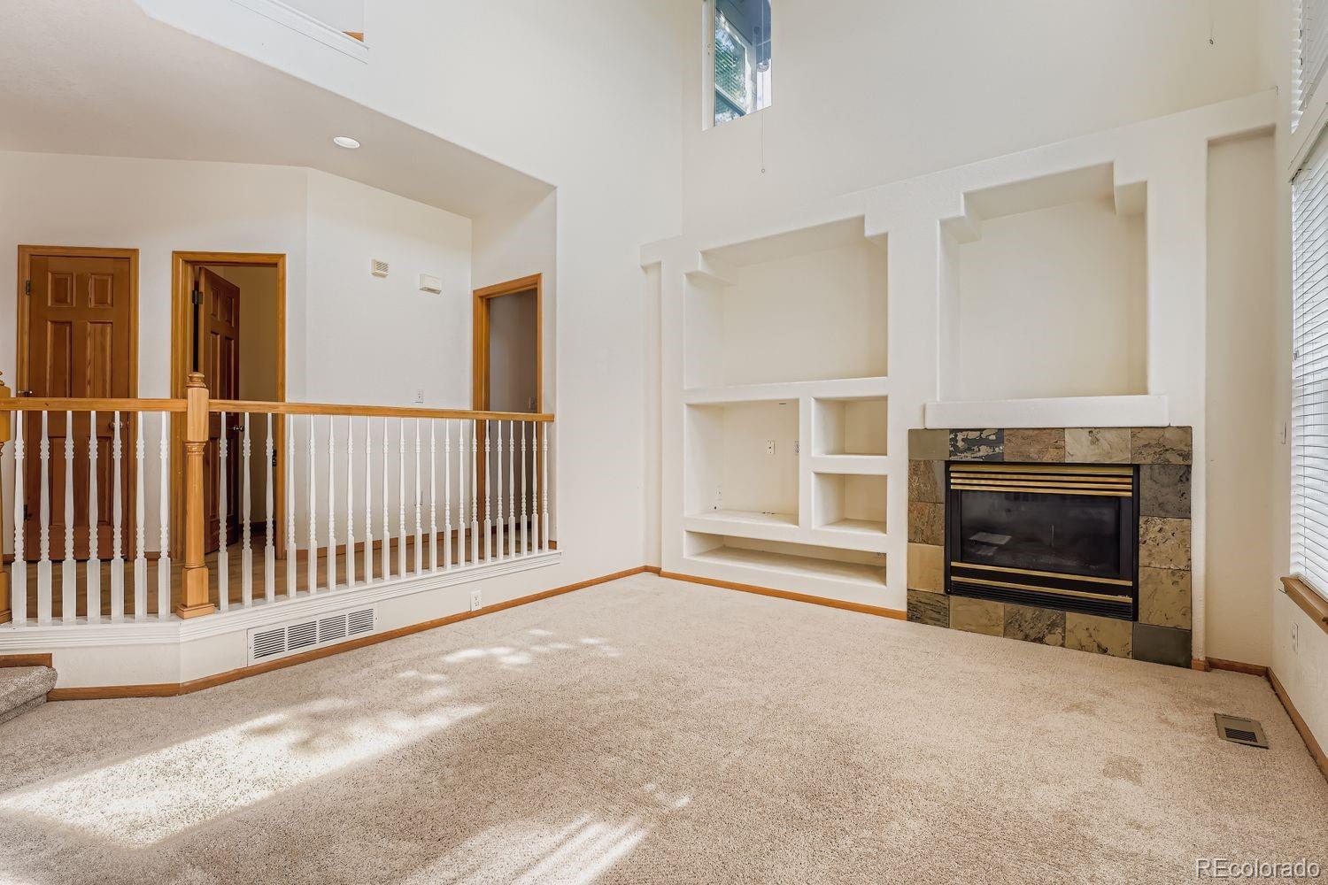 20758 East Maplewood Lane Centennial, CO 80016 - Photo 13 of 29 a view of a livingroom with a fireplace