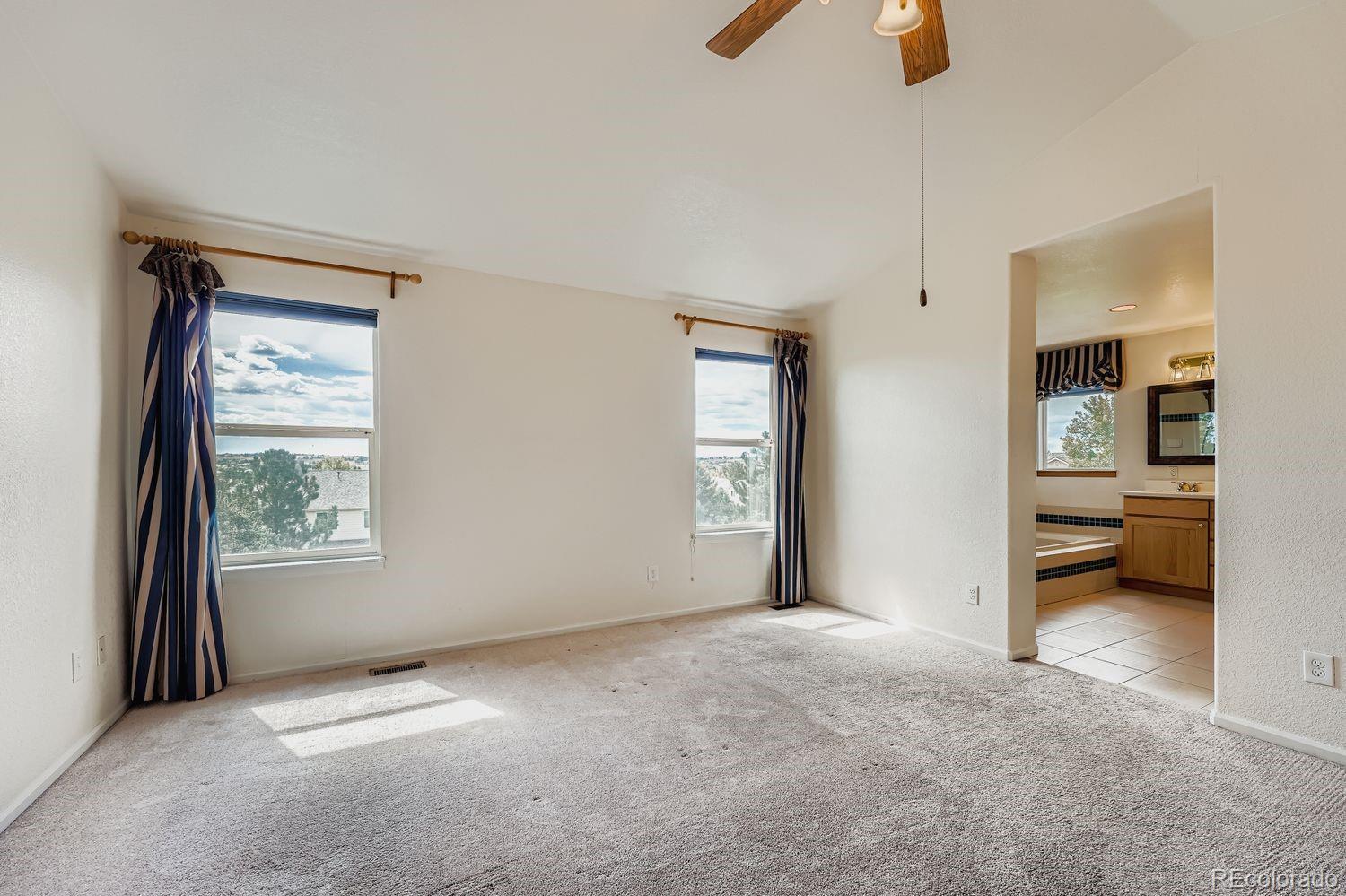 20758 East Maplewood Lane Centennial, CO 80016 - Photo 14 of 29 a view of an empty room with a window and a kitchen
