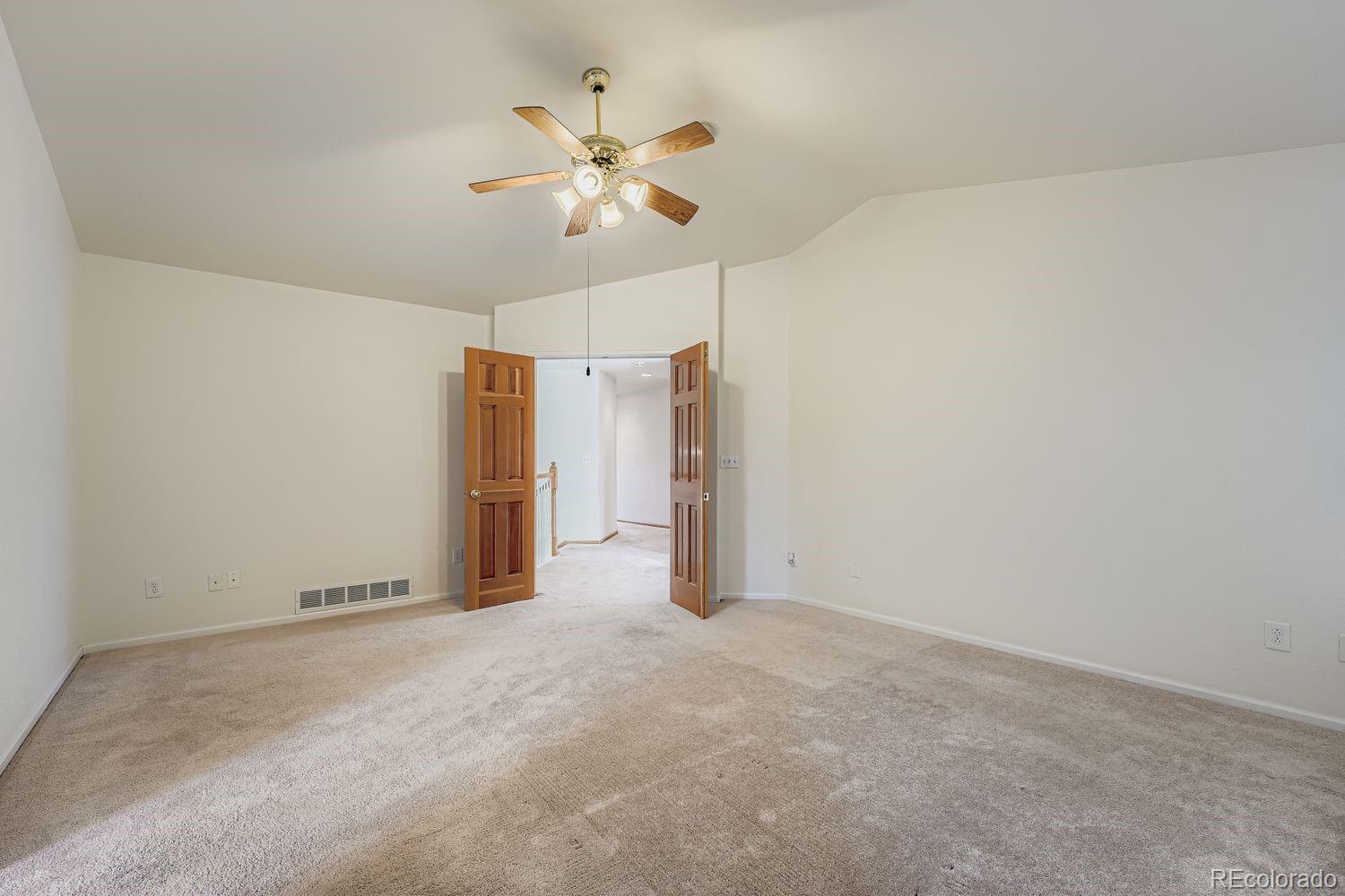 20758 East Maplewood Lane Centennial, CO 80016 - Photo 15 of 29 a view of an empty room with a chandelier fan