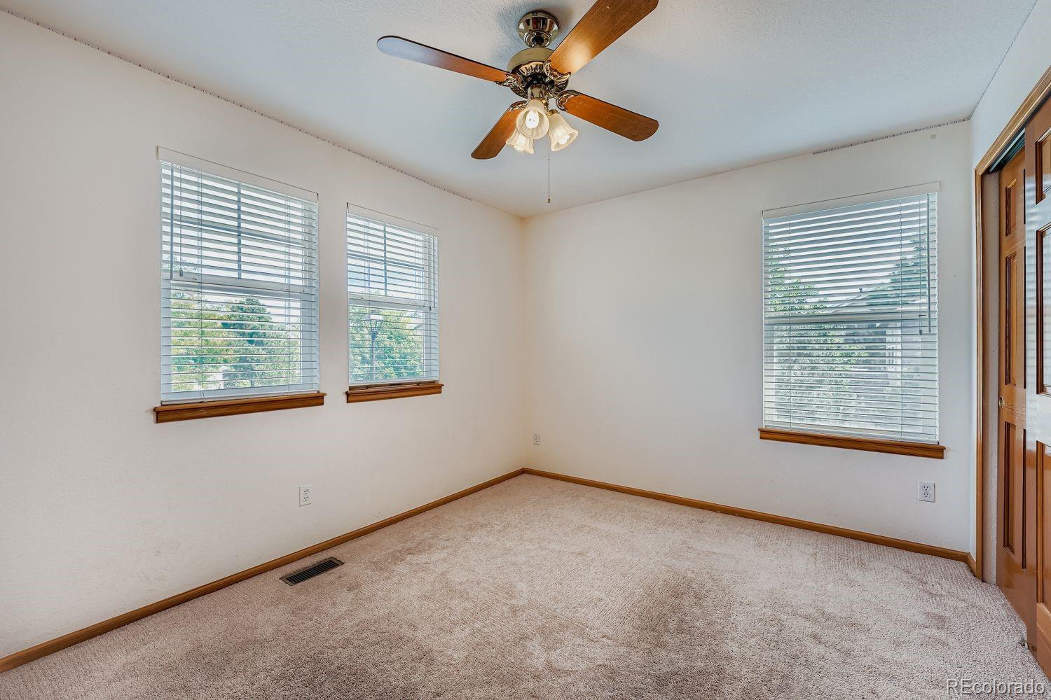 20758 East Maplewood Lane Centennial, CO 80016 - Photo 18 of 29 an empty room with windows and fan
