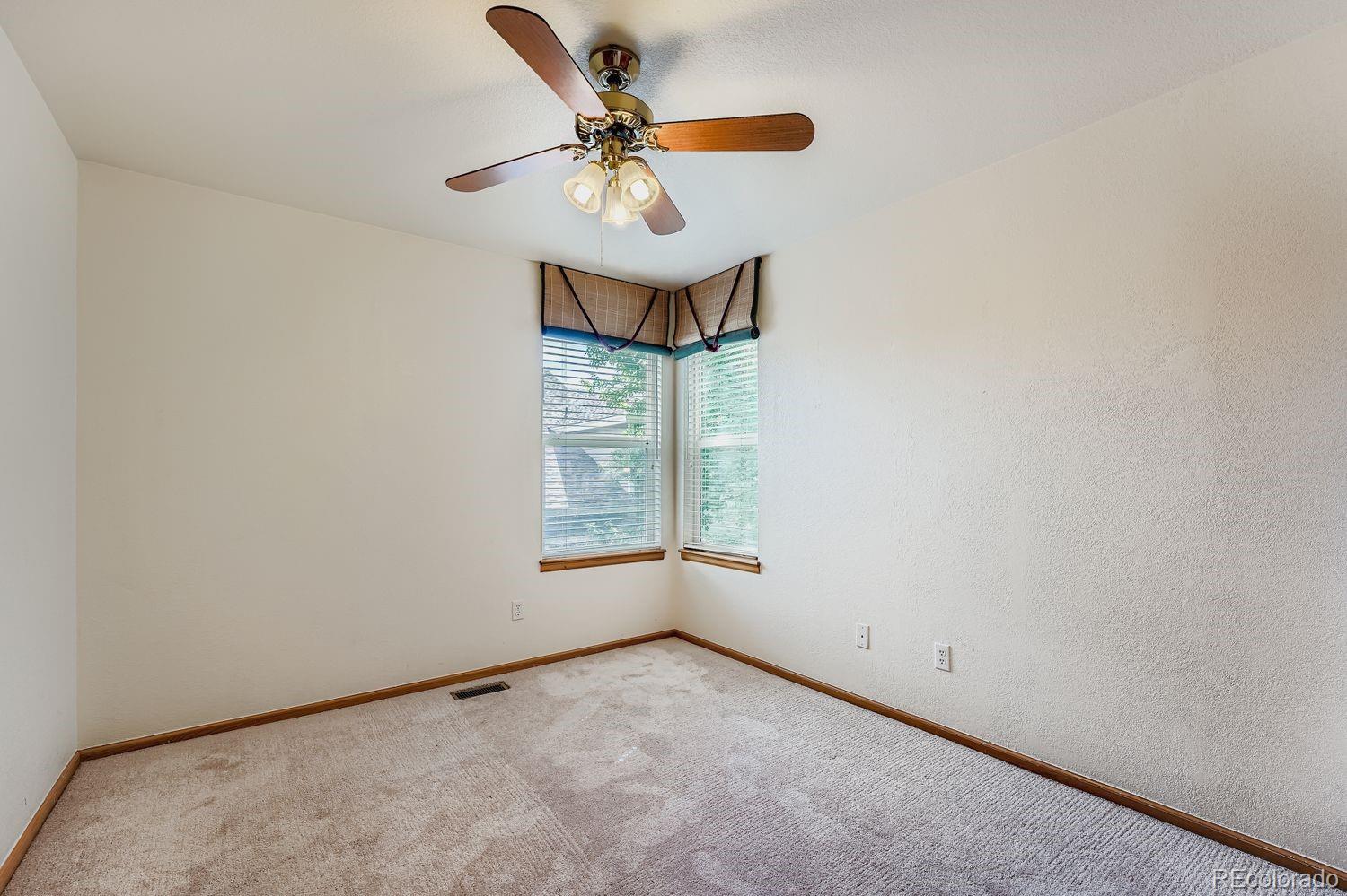 20758 East Maplewood Lane Centennial, CO 80016 - Photo 19 of 29 an empty room with a window and a fan