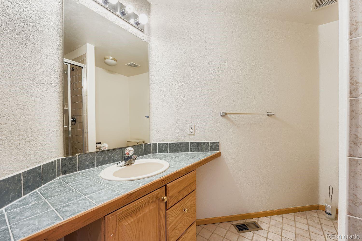 20758 East Maplewood Lane Centennial, CO 80016 - Photo 21 of 29 a bathroom with a sink and a mirror