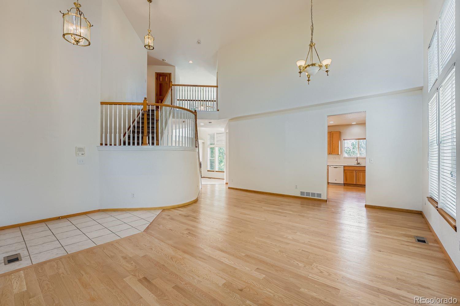 20758 East Maplewood Lane Centennial, CO 80016 - Photo 4 of 29 a view of an empty room with wooden floor and a window