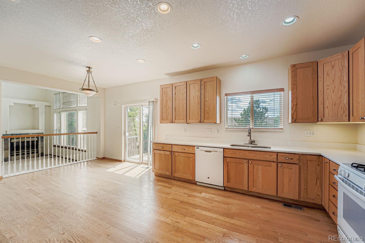 20758 East Maplewood Lane Centennial, CO 80016 - Photo 8 of 29 a large kitchen with stainless steel appliances granite countertop a sink and cabinets