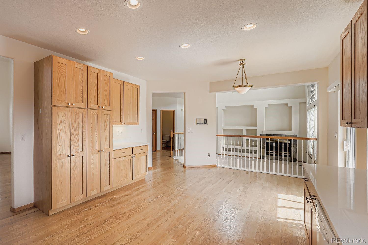 20758 East Maplewood Lane Centennial, CO 80016 - Photo 9 of 29 an empty room with wooden floor cabinet and windows