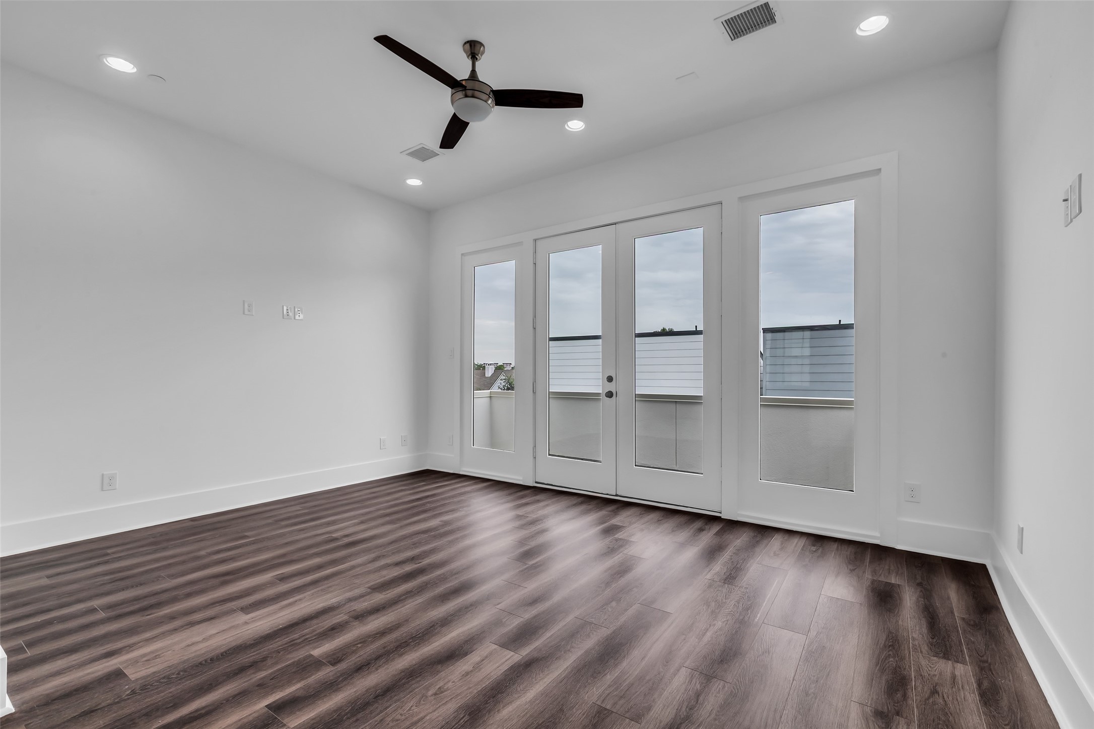 2716 Baldwin Street Houston, TX 77006 - Photo 23 of 26 Double glass-paneled doors open to a balcony with a view of the neighborhood.