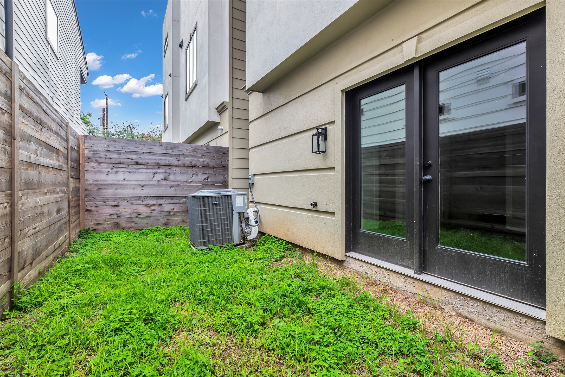 2716 Baldwin Street Houston, TX 77006 - Photo 25 of 26 This open back patio connects directly to the versatile first-floor room, creating a convenient extension of the indoor living space.
