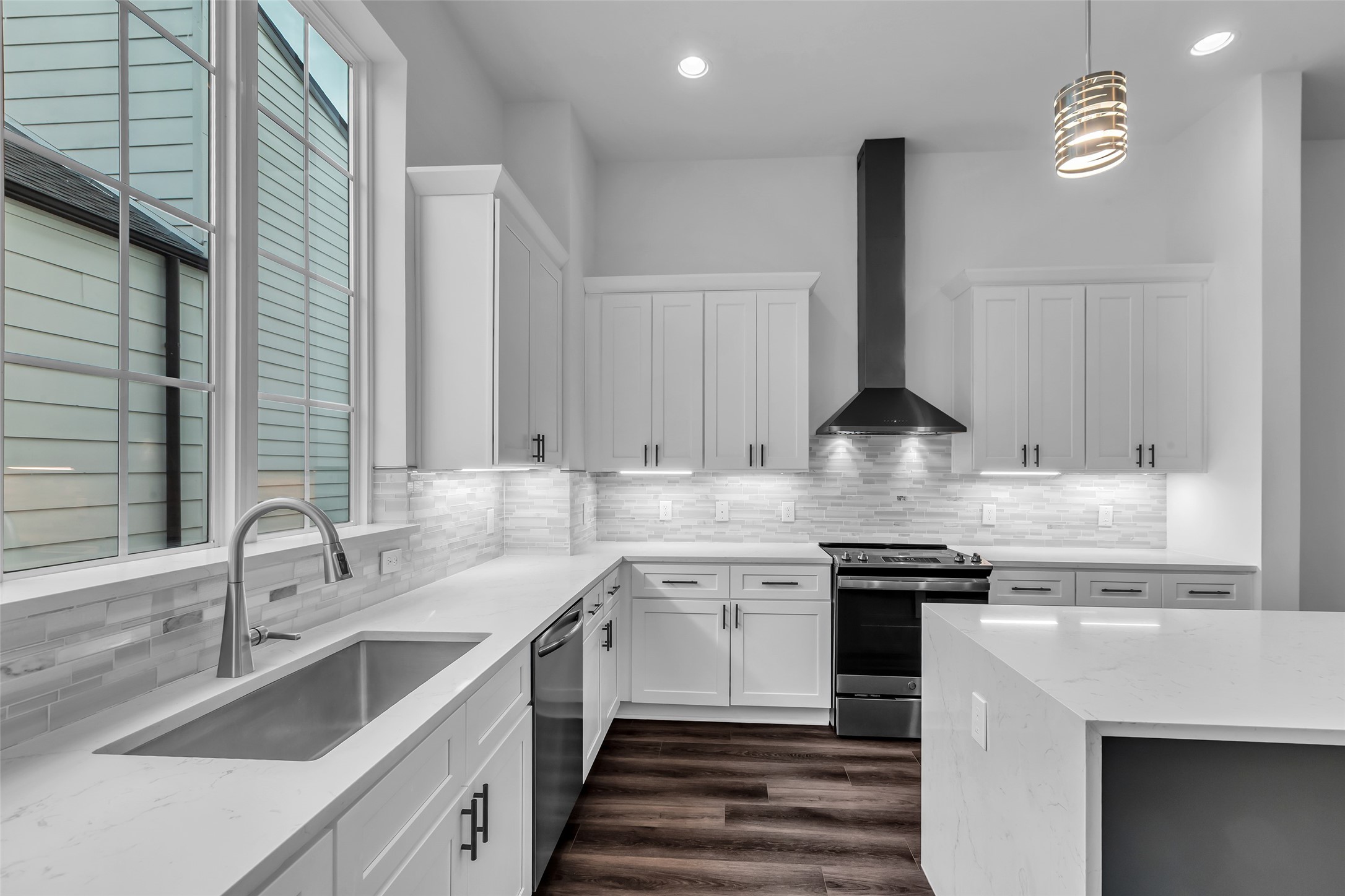 2716 Baldwin Street Houston, TX 77006 - Photo 5 of 26 A large window by the sink fills the kitchen with natural light, creating a bright and inviting space for daily use.