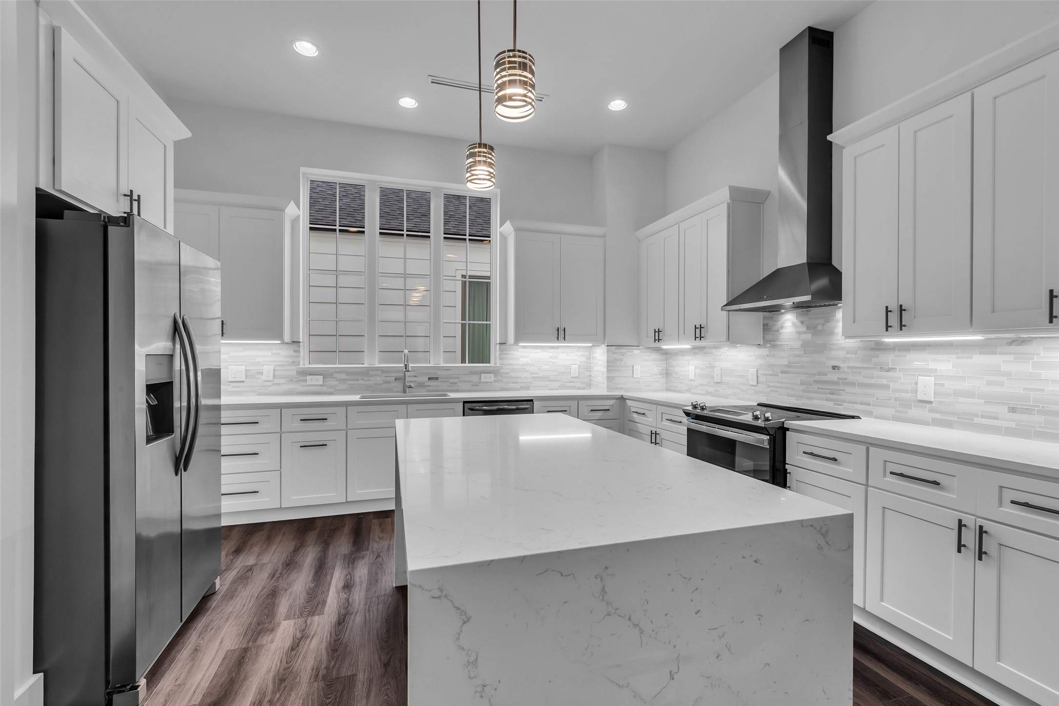 2716 Baldwin Street Houston, TX 77006 - Photo 7 of 26 At the center of the kitchen is a functional island, providing extra workspace and making meal preparation more convenient.