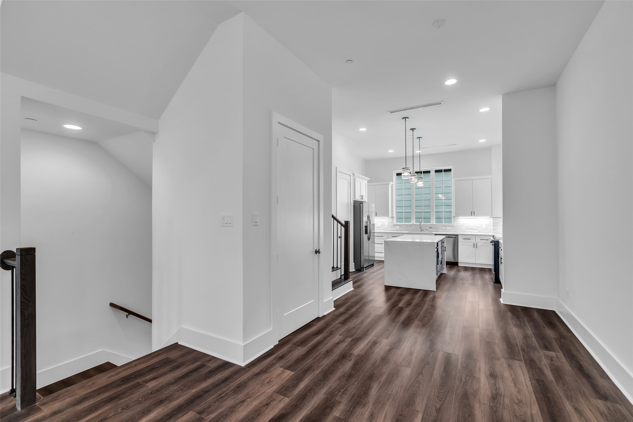 2716 Baldwin Street Houston, TX 77006 - Photo 9 of 26 Between the kitchen and living area, there’s a small room perfect for extra storage. From this spot, you can also see the staircase that leads down to the first floor.
