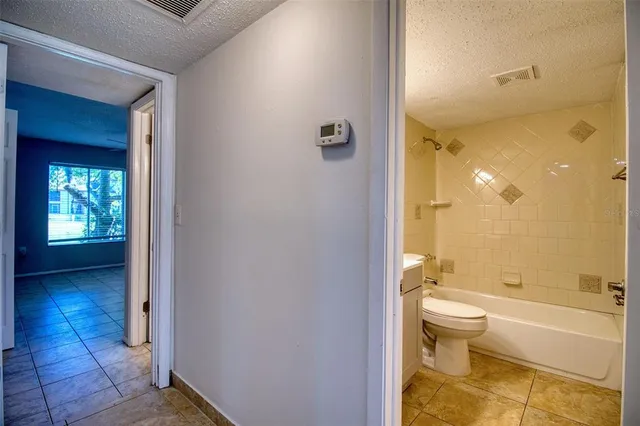 a bathroom with a toilet a sink and bathtub