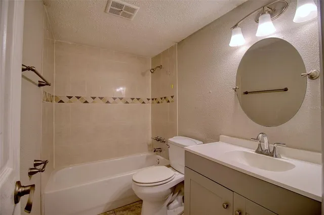 a bathroom with a double vanity sink toilet mirror and bathtub