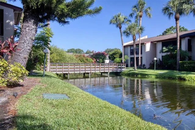 a view of a lake with a building and a garden
