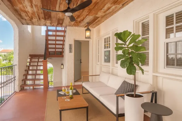 a living room with furniture and a potted plant