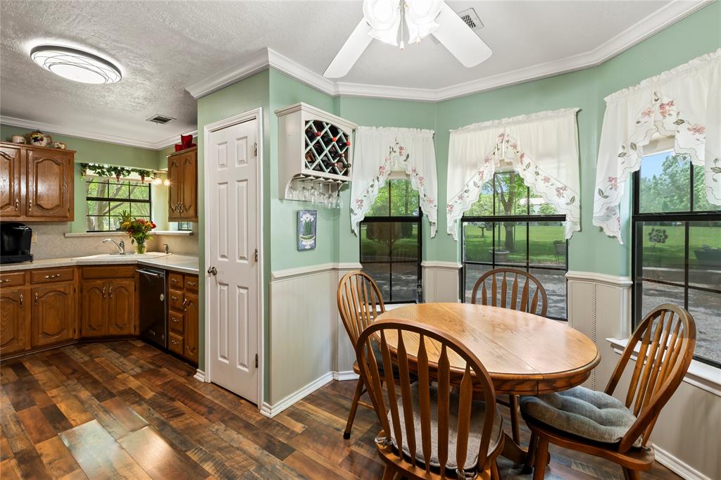 455 Stirrup Ranch Road Trinidad, TX 75163 - Photo 8 of 20 a kitchen with stainless steel appliances granite countertop a dining table chairs refrigerator and sink