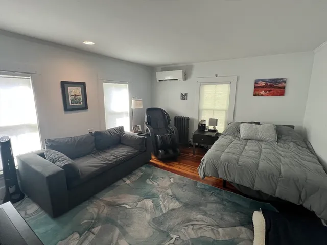 a living room with furniture and a book shelf