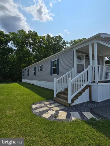 a view of a house with a yard and deck