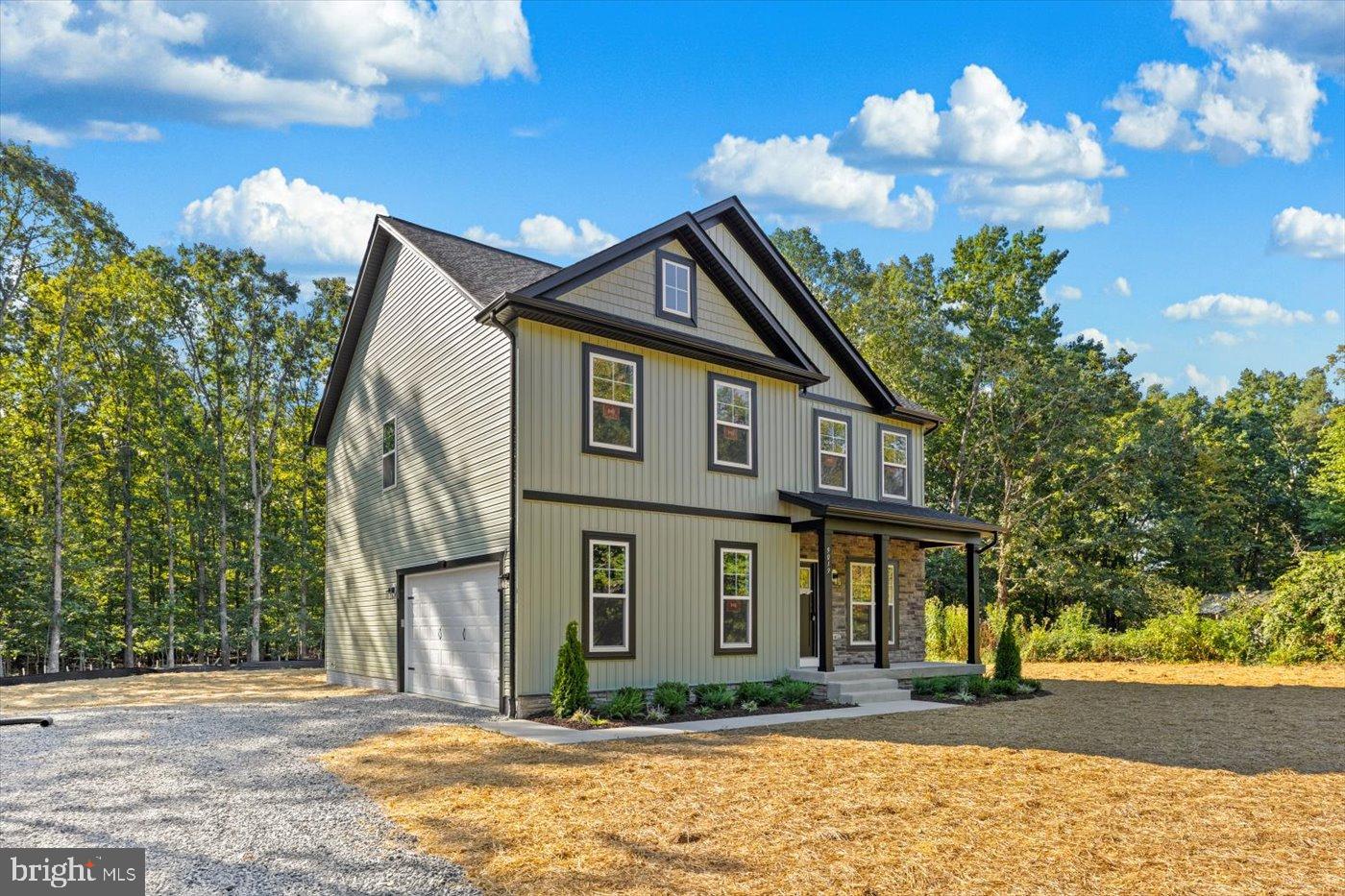 9019 Smiths Bend Road Fredericksburg, VA 22407 - Photo 1 of 57 a front view of a house with garden