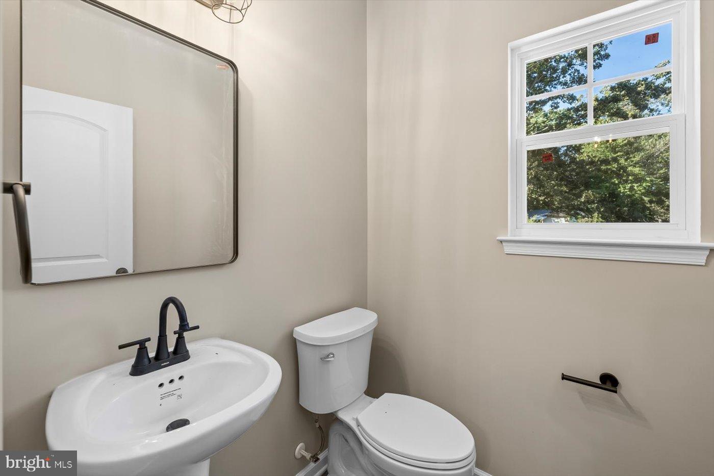9019 Smiths Bend Road Fredericksburg, VA 22407 - Photo 21 of 57 a bathroom with a sink mirror and toilet