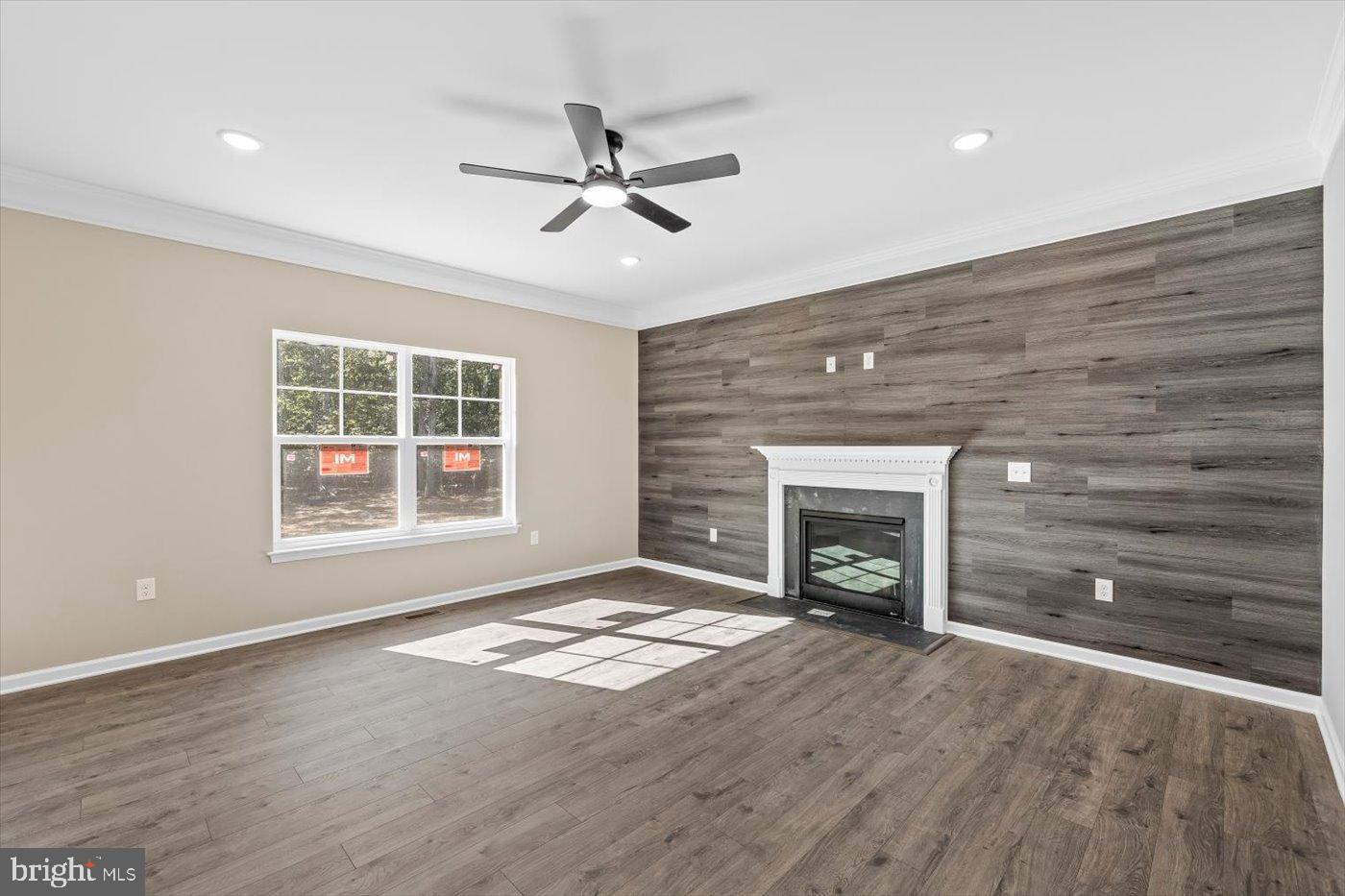9019 Smiths Bend Road Fredericksburg, VA 22407 - Photo 23 of 57 a view of an empty room with wooden floor fireplace and a window
