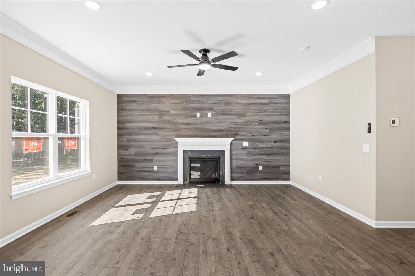 9019 Smiths Bend Road Fredericksburg, VA 22407 - Photo 24 of 57 a view of wooden floor fire place and windows in a room