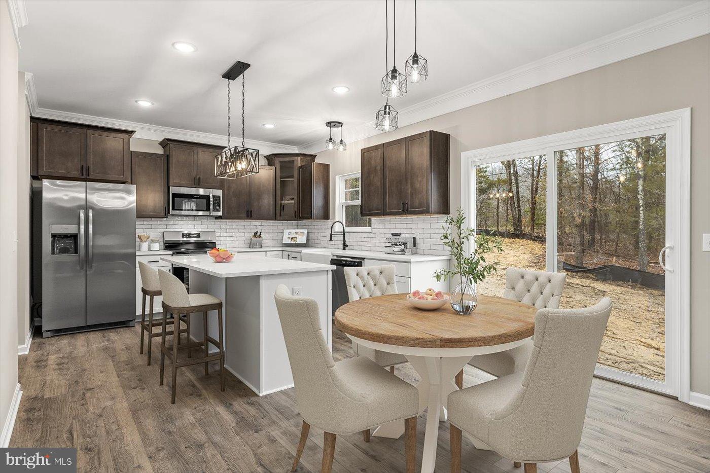 9019 Smiths Bend Road Fredericksburg, VA 22407 - Photo 5 of 57 a kitchen with stainless steel appliances a dining table chairs stove refrigerator and microwave