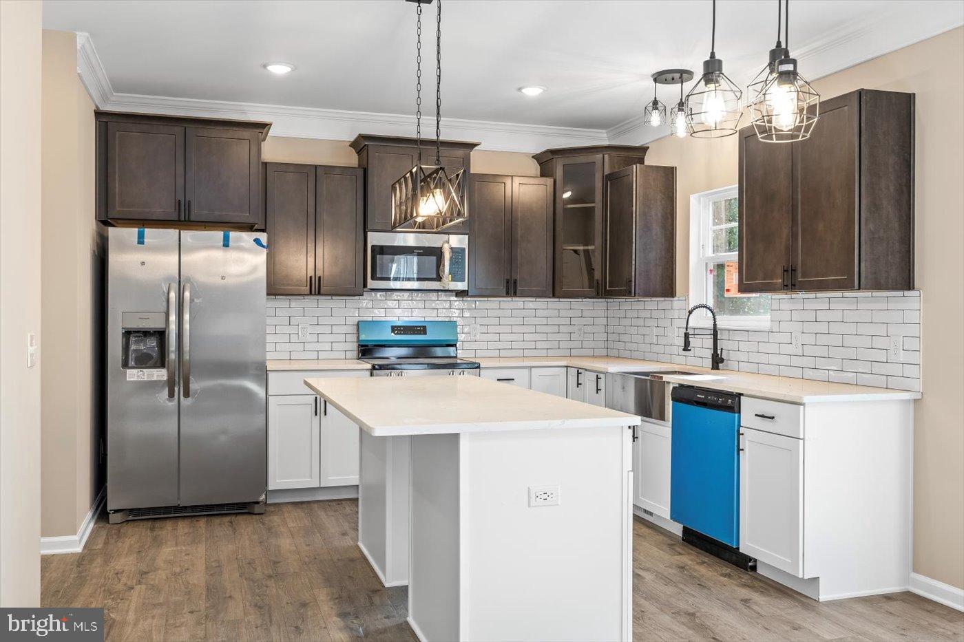 9019 Smiths Bend Road Fredericksburg, VA 22407 - Photo 10 of 57 a kitchen with stainless steel appliances a sink a refrigerator a center island a stove and cabinets
