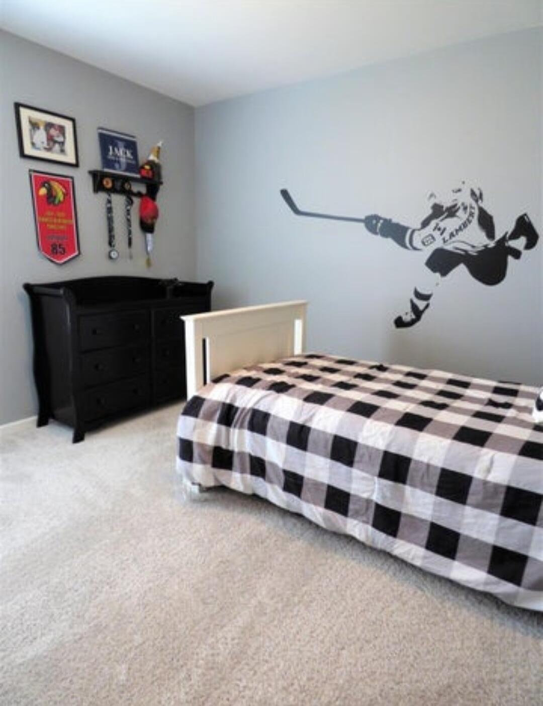 636 East 119th Place Crown Point, IN 46307 - Photo 21 of 35 a bedroom with a bed and a chandelier