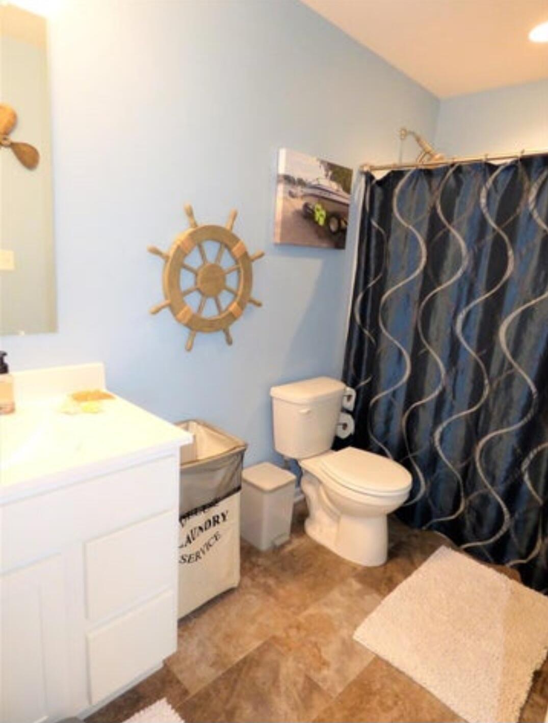 636 East 119th Place Crown Point, IN 46307 - Photo 24 of 35 a bathroom with a toilet sink vanity and mirror