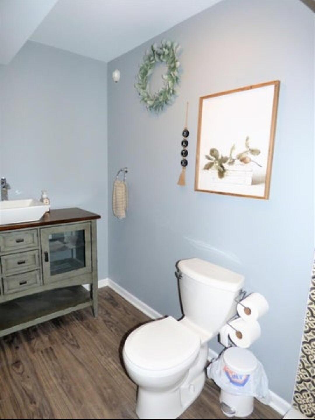 636 East 119th Place Crown Point, IN 46307 - Photo 29 of 35 a white toilet sitting next to a bathroom sink and a mirror