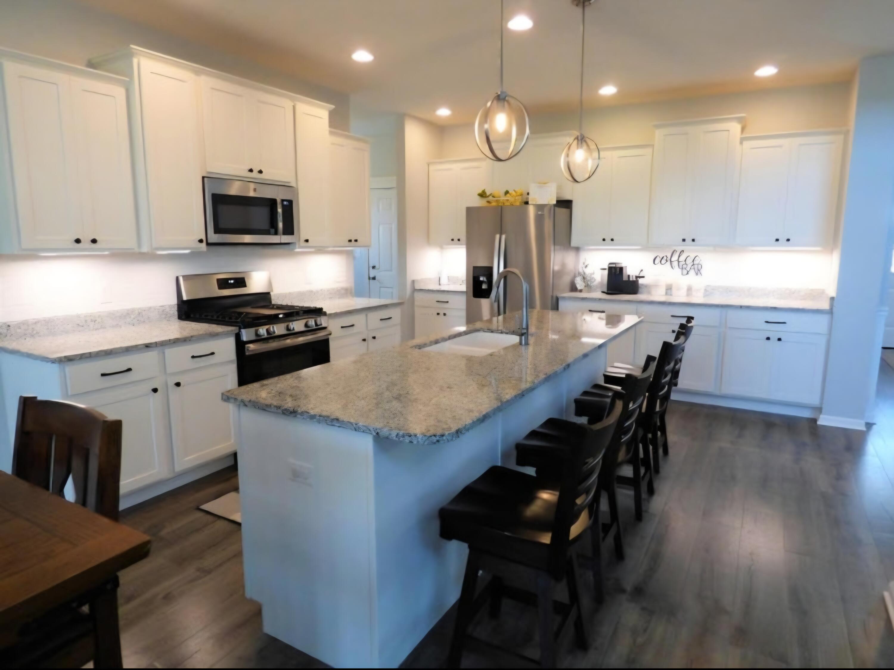 636 East 119th Place Crown Point, IN 46307 - Photo 6 of 35 a large kitchen with cabinets chairs and wooden floor