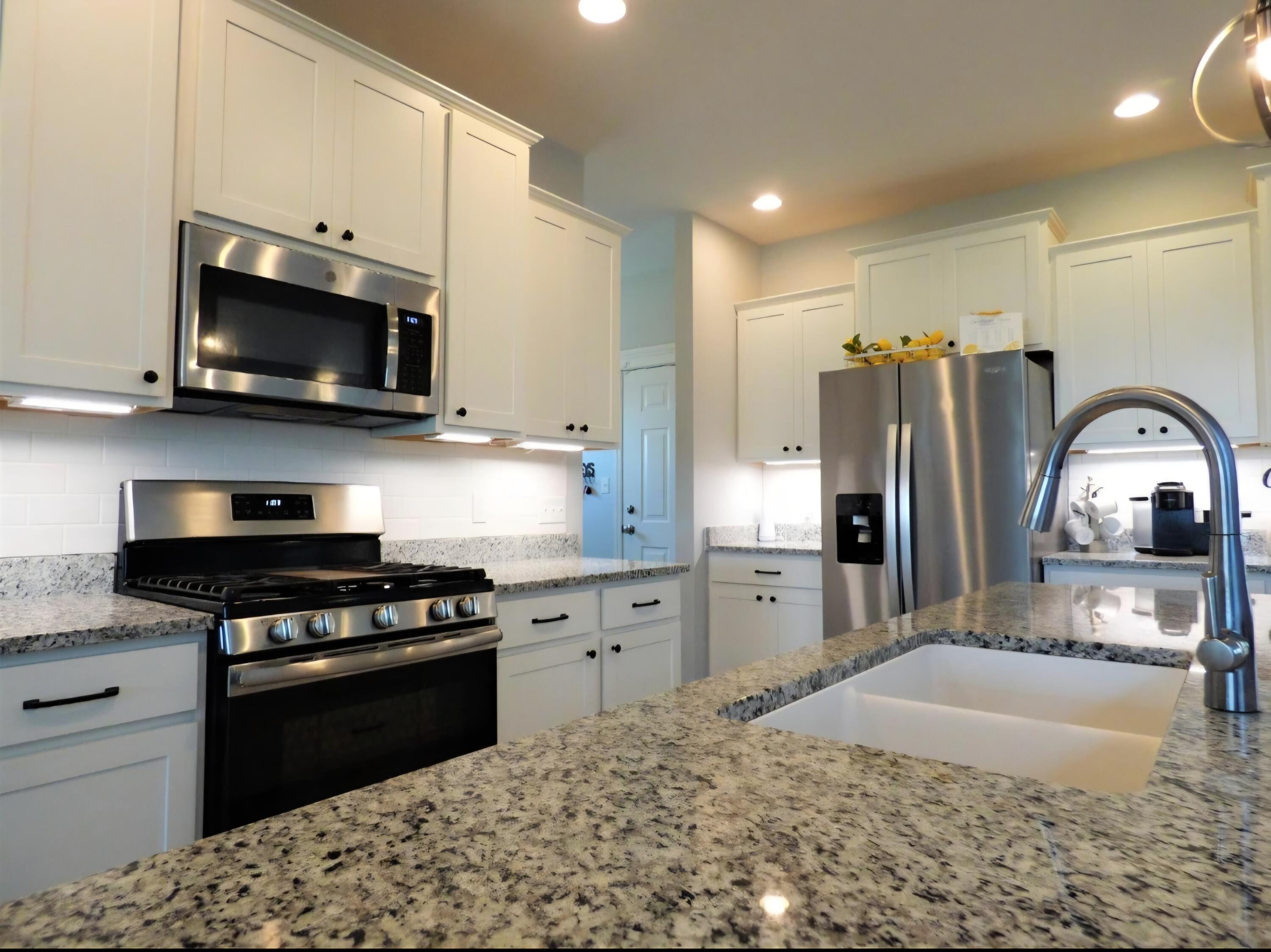 636 East 119th Place Crown Point, IN 46307 - Photo 8 of 35 a kitchen with stainless steel appliances granite countertop a stove a sink and a microwave