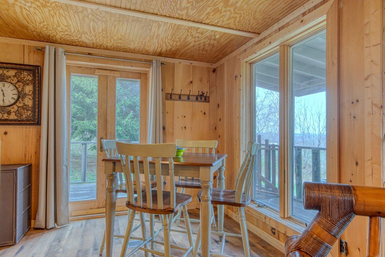 1696 Green Valley Road Peterstown, WV 24963 - Photo 102 of 132 a view of a dining room with furniture window and wooden floor