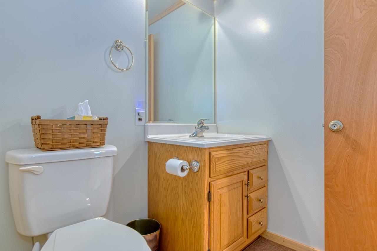 1696 Green Valley Road Peterstown, WV 24963 - Photo 116 of 132 a bathroom with a granite countertop toilet sink and mirror