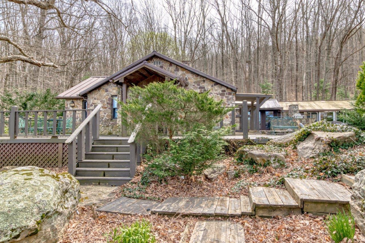 1696 Green Valley Road Peterstown, WV 24963 - Photo 19 of 132 a backyard of a house with large trees and plants