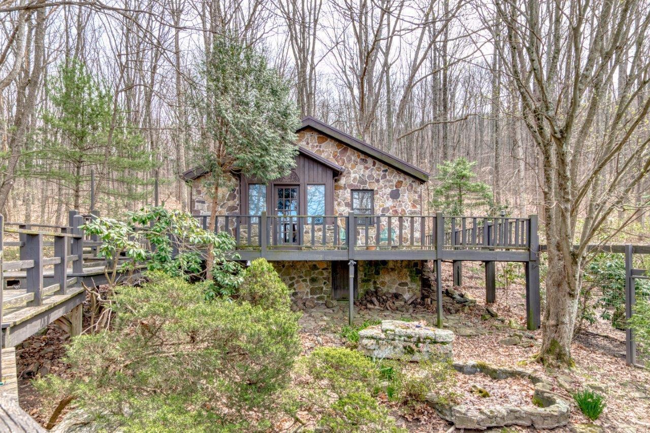 1696 Green Valley Road Peterstown, WV 24963 - Photo 69 of 132 a backyard of a house with table and chairs under an umbrella