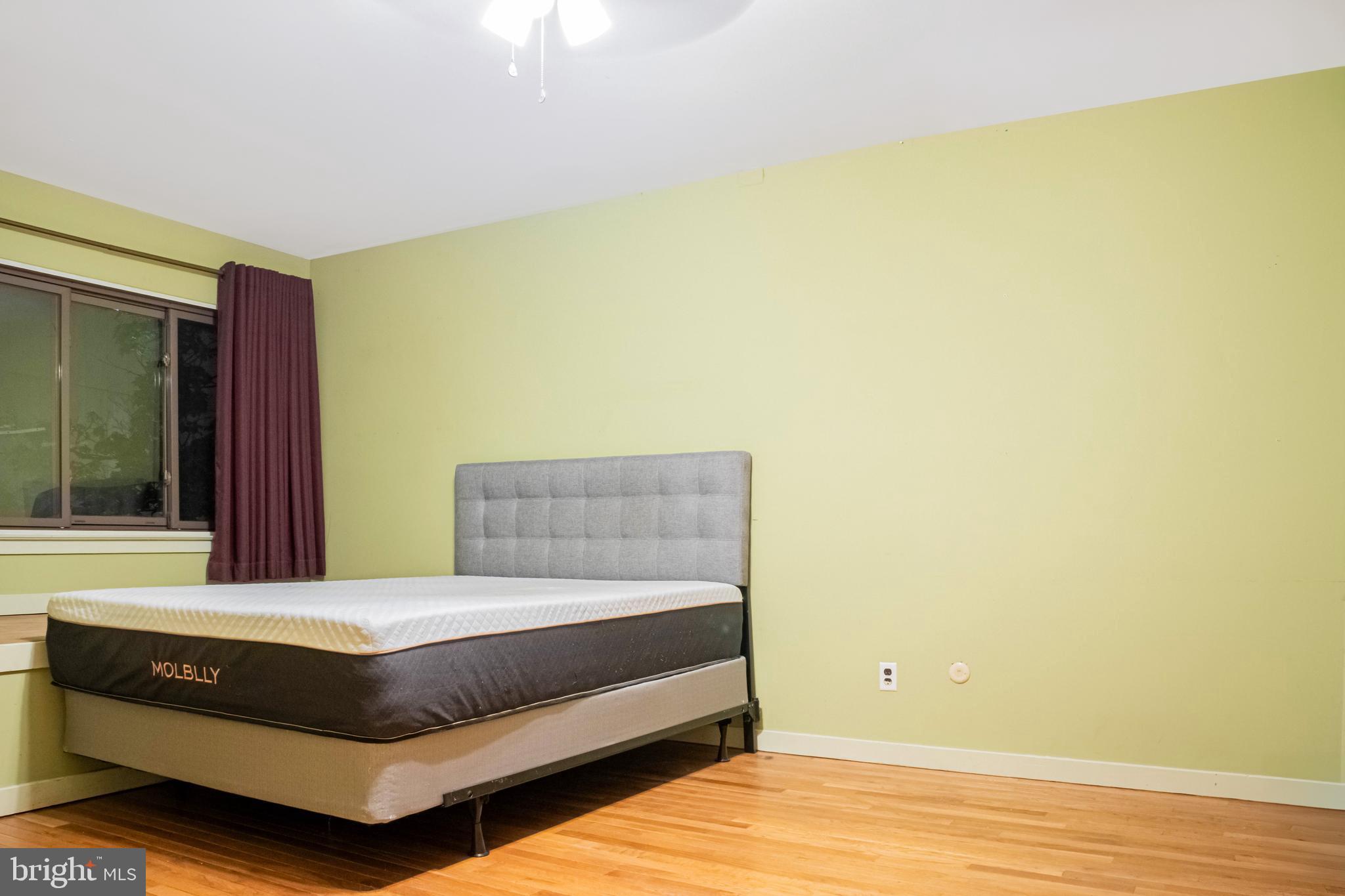 906 Locust Street Philadelphia, PA 19107 - Photo 11 of 46 a bedroom with a bed and a window
