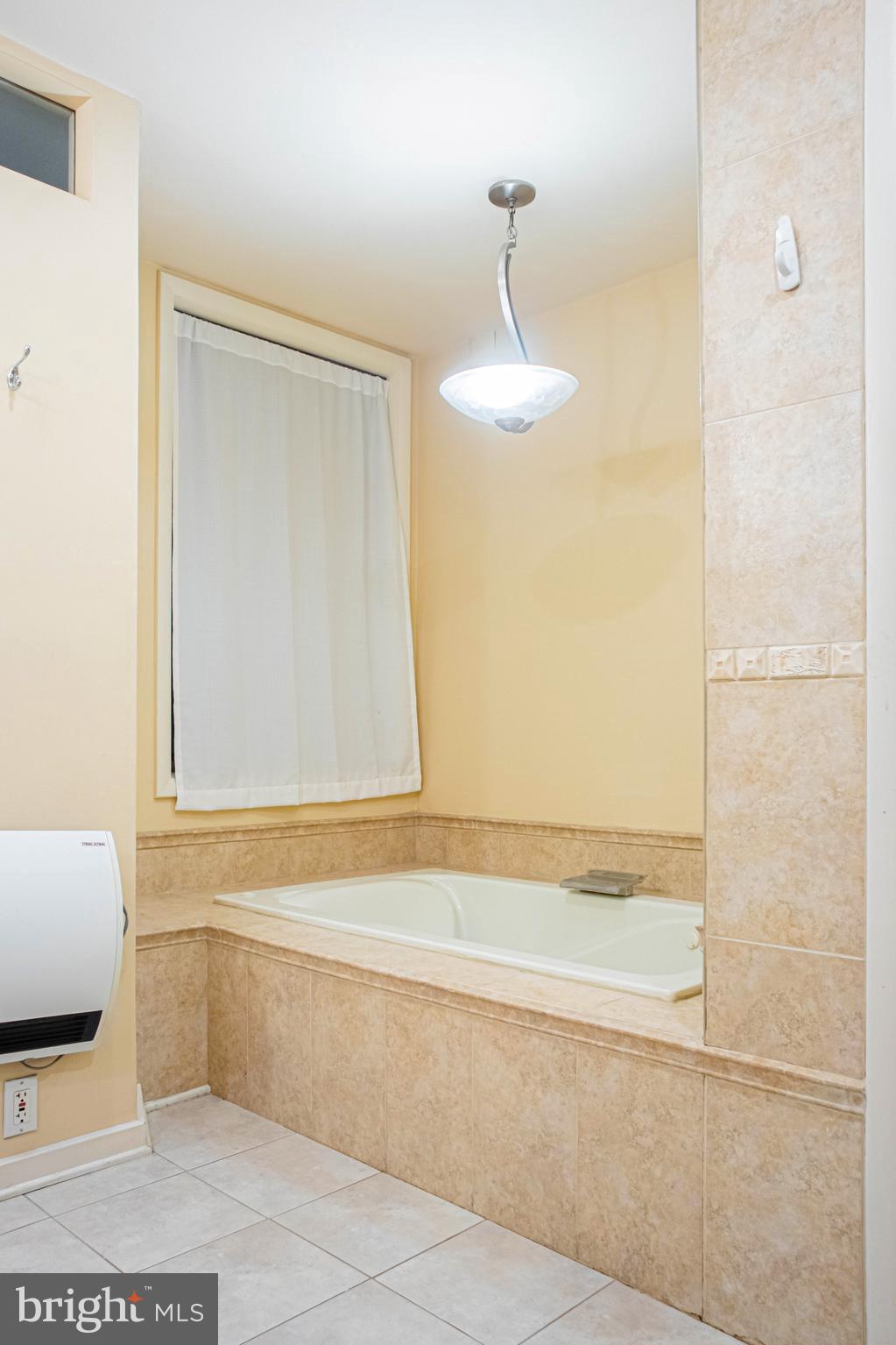 906 Locust Street Philadelphia, PA 19107 - Photo 18 of 46 a bathroom with a bathtub and a shower