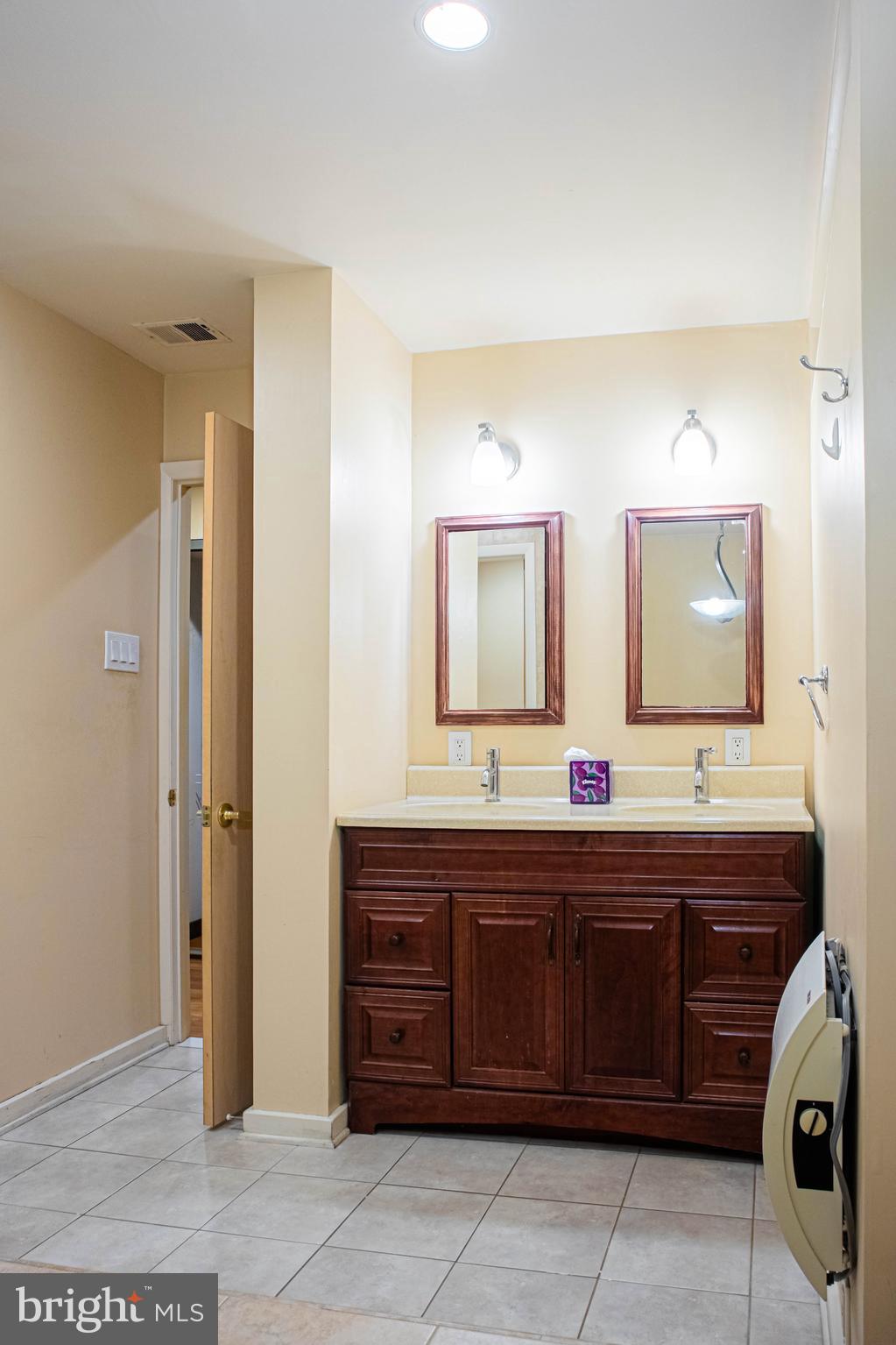 906 Locust Street Philadelphia, PA 19107 - Photo 20 of 46 a large bathroom with a double vanity sink and a mirror