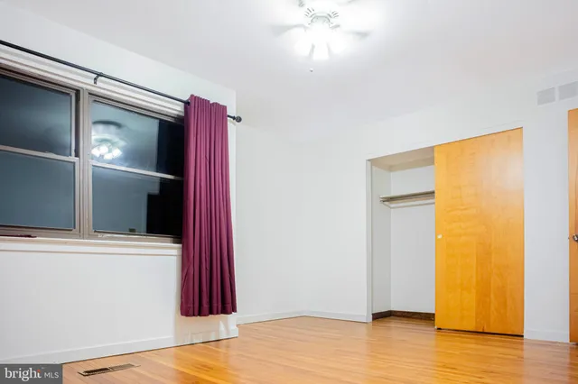 a view of a room with wooden floor