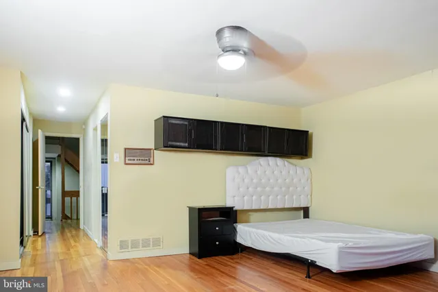 a view of a room with wooden floors and a chandelier