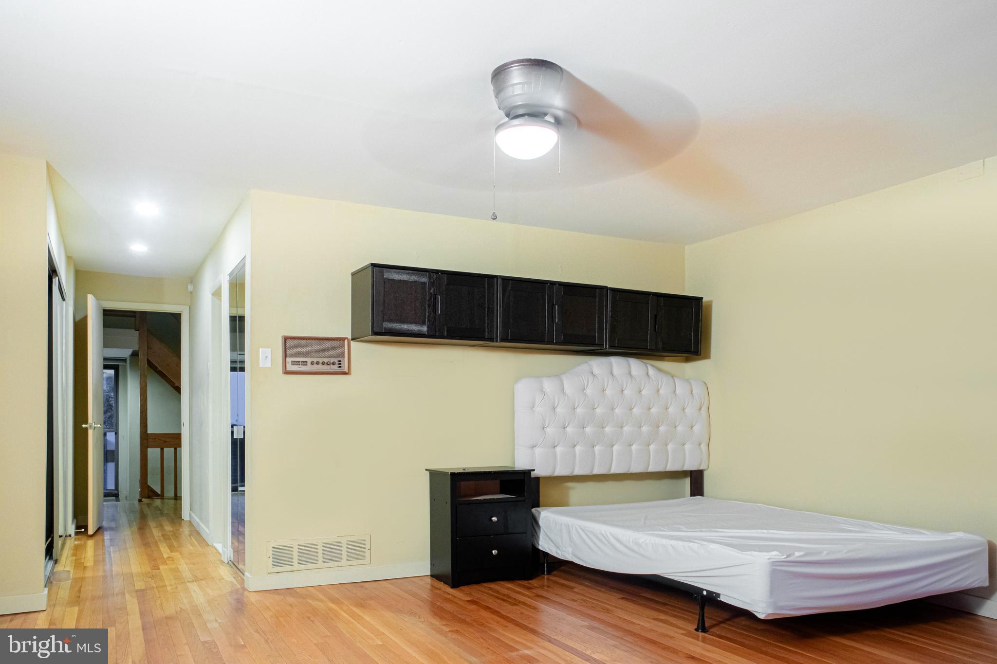 906 Locust Street Philadelphia, PA 19107 - Photo 23 of 46 a bedroom with a bed and wooden floor