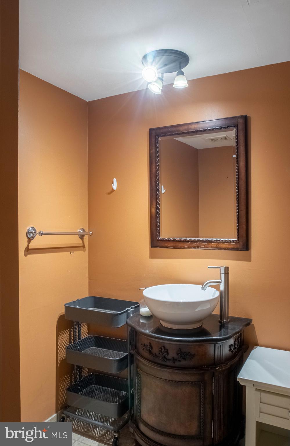 906 Locust Street Philadelphia, PA 19107 - Photo 26 of 46 a bathroom with a sink and a mirror