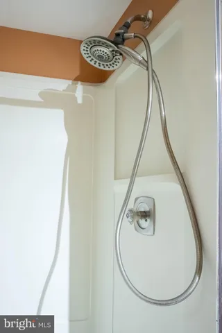 a white toilet sitting next to a white wall