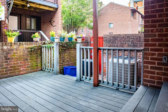 a kitchen with kitchen island granite countertop a large counter space stainless steel appliances and cabinets