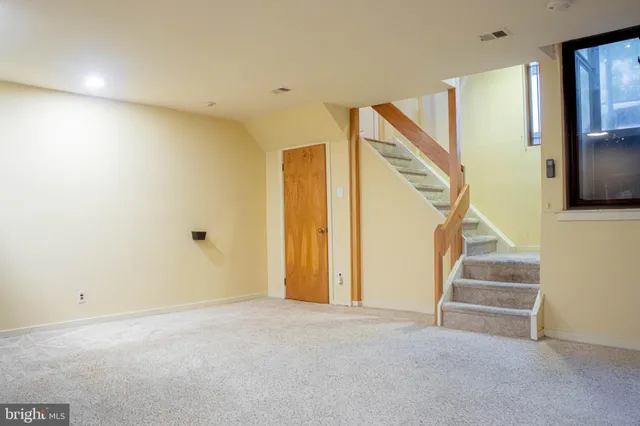 a view of an empty room with a fireplace