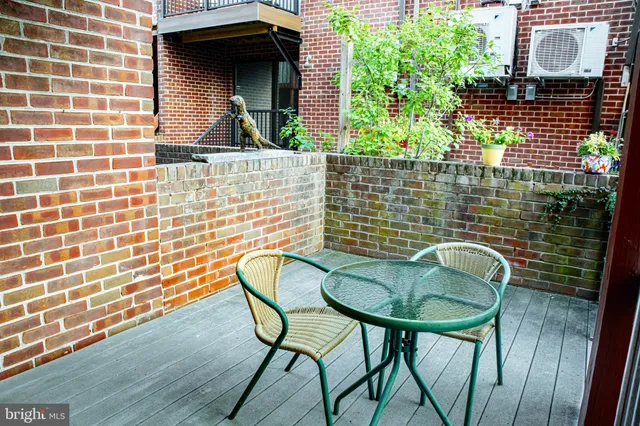 a kitchen with stainless steel appliances granite countertop a table chairs and a refrigerator