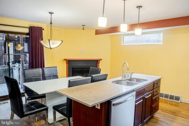 a kitchen with a stove and a wooden floor