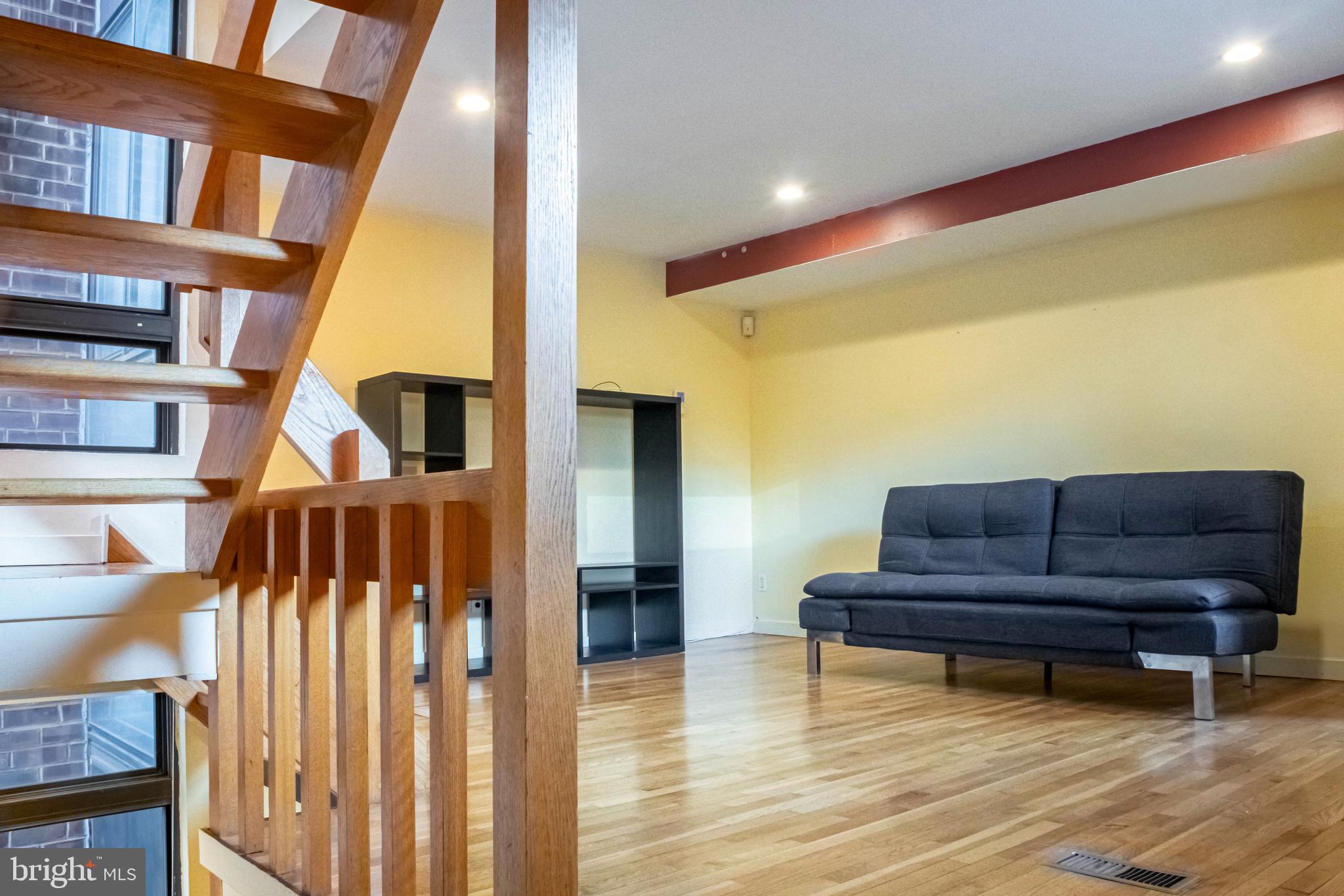906 Locust Street Philadelphia, PA 19107 - Photo 39 of 46 a living room with furniture and a wooden floor