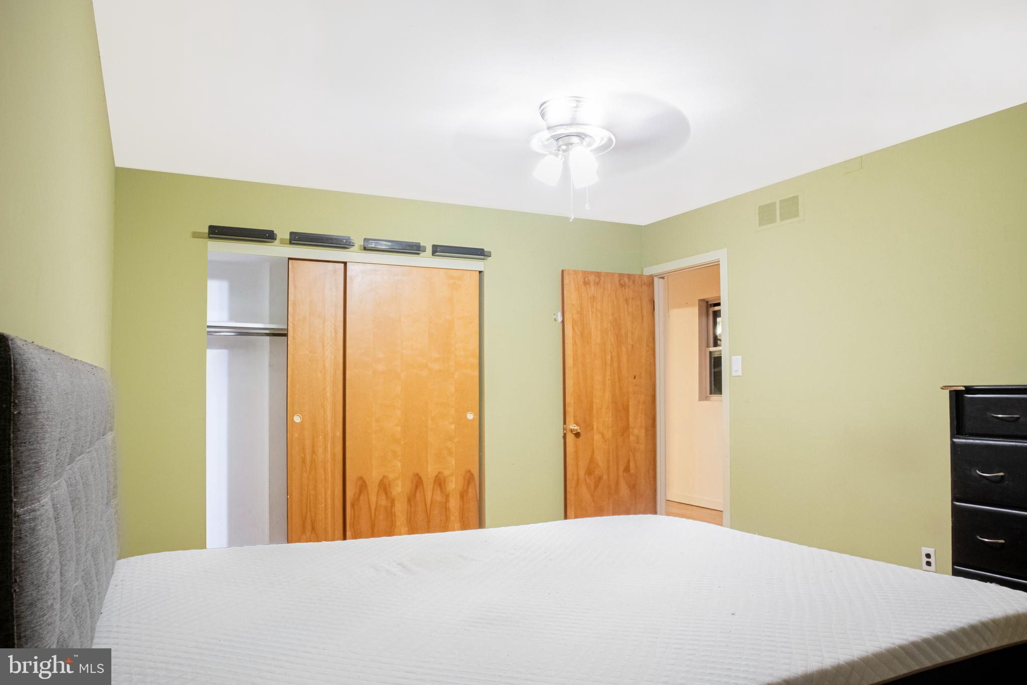 906 Locust Street Philadelphia, PA 19107 - Photo 10 of 46 a bedroom with a bed and a chandelier